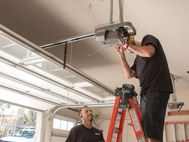Titletown Garage Door install crew mounting a garage door opener in a Green Bay home